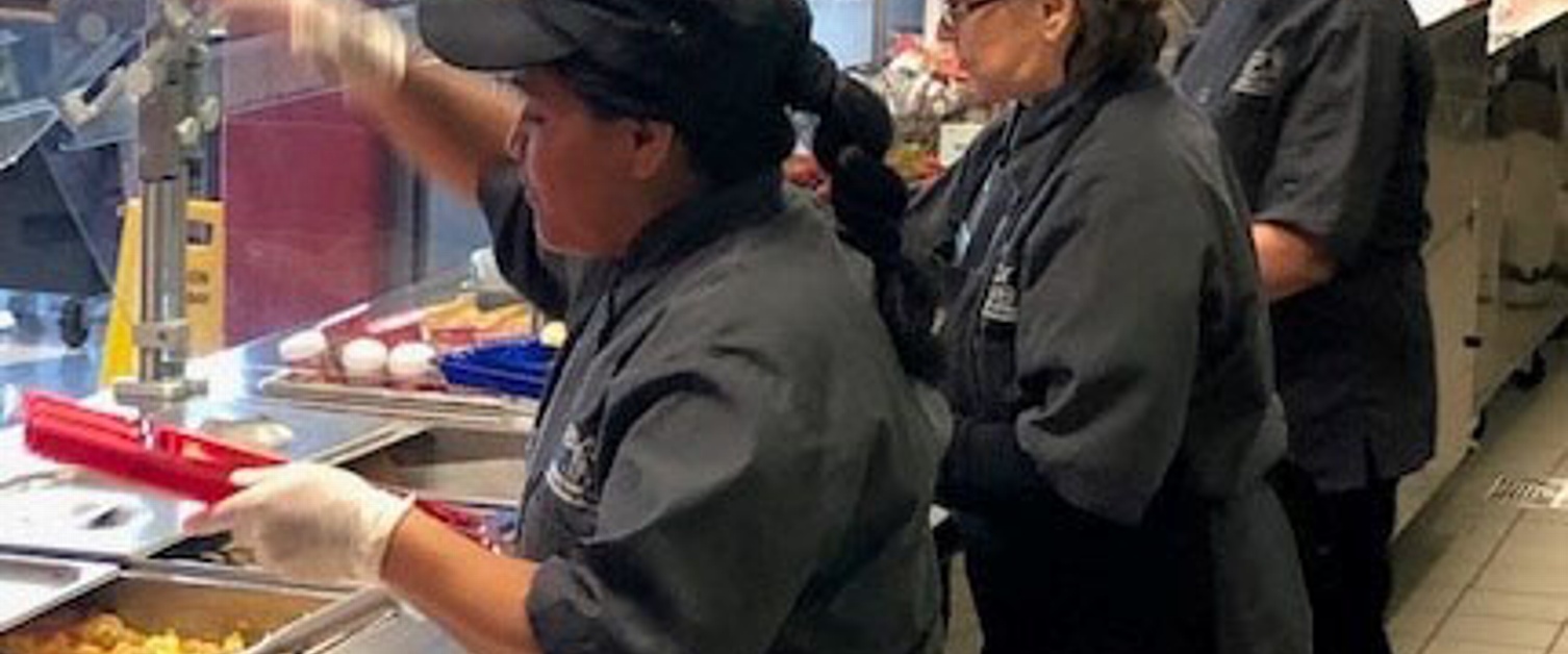 Lunchroom workers serving meals